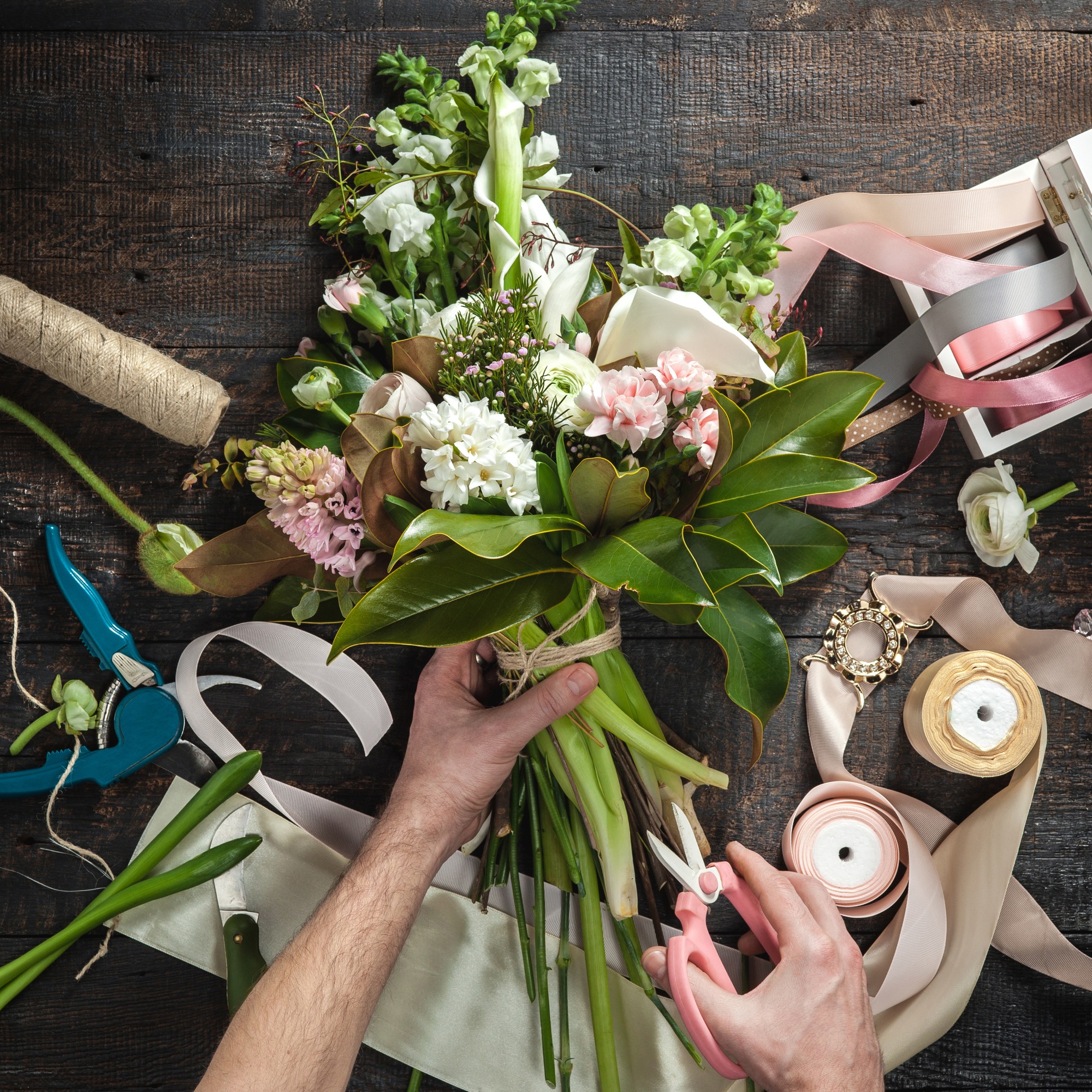 The florist desktop with working tools and ribbons